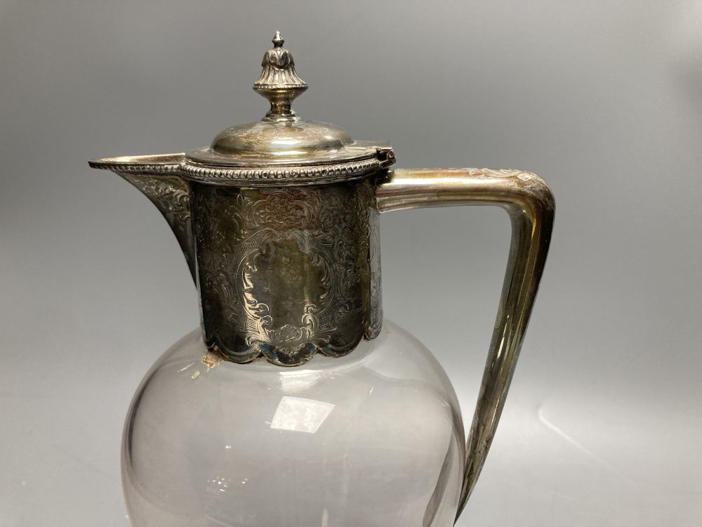 An Edwardian engraved silver mounted inverted pear shaped pedestal glass claret jug, Atkin Brothers, Sheffield, 1906?, 28.8cm.